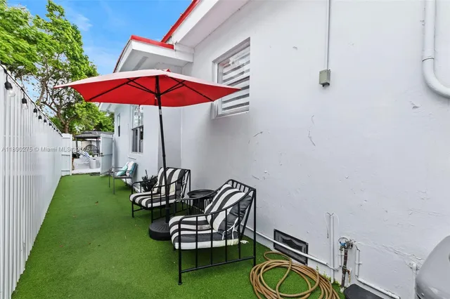 a view of chairs and table in the backyard
