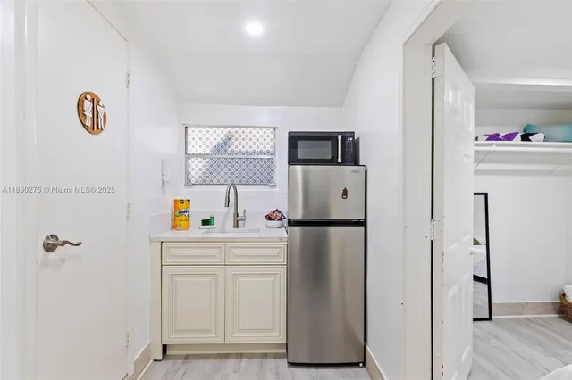 a white refrigerator freezer sitting inside of a kitchen
