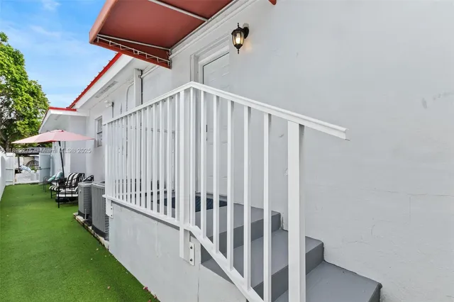 a view of a house with backyard porch and sitting area