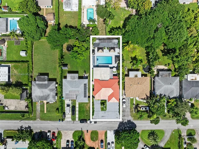 an aerial view of multiple houses with a yard