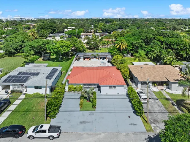 an aerial view of multiple houses with yard