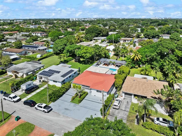 an aerial view of a houses with a yard