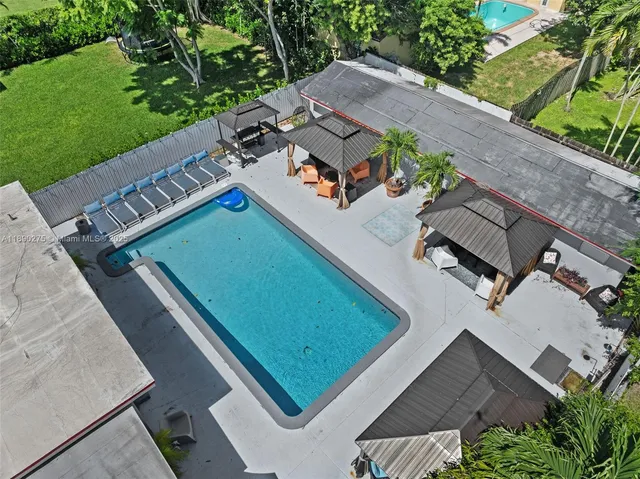 an aerial view of multiple houses with yard