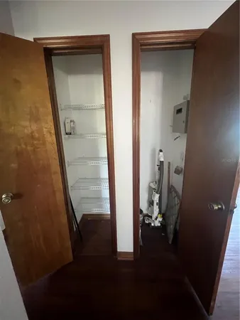 a view of hallway with a table and chairs