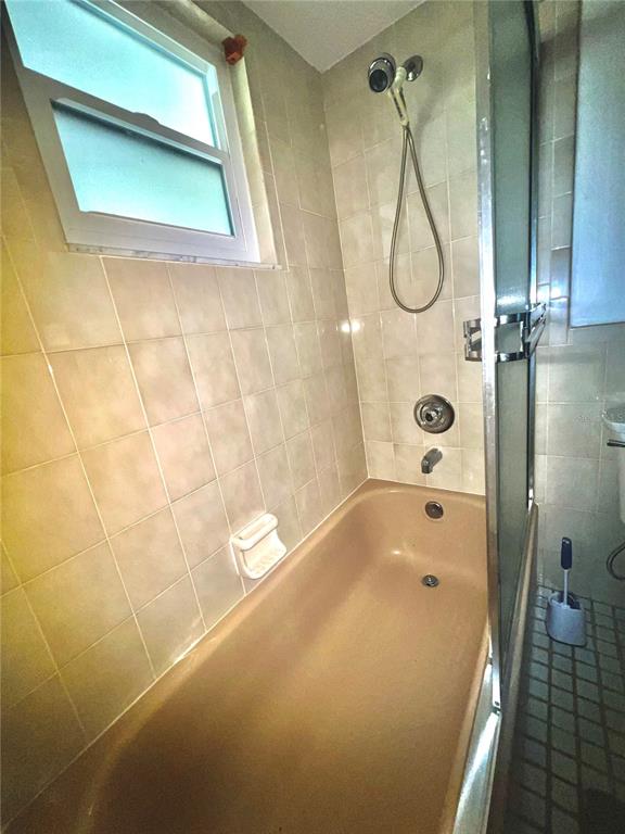 13020 Sun Road Brooksville, FL 34613 - Photo 22 of 33 a bathroom with a bathtub and shower