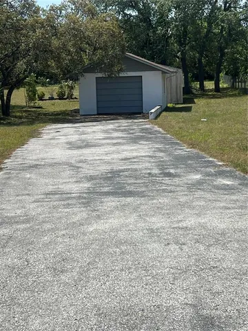 a tall yellow house with a yard