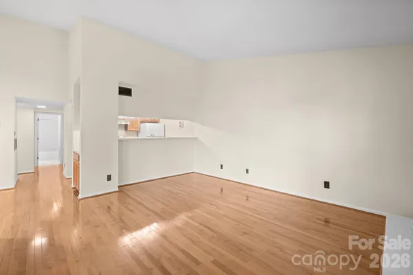 a view of a room with wooden floor
