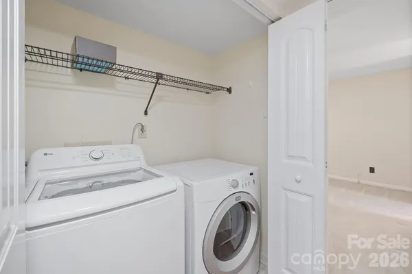 a view of storage and utility room with washer and dryer
