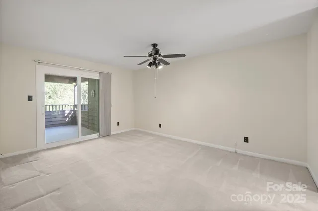 a view of a room with a ceiling fan and a window
