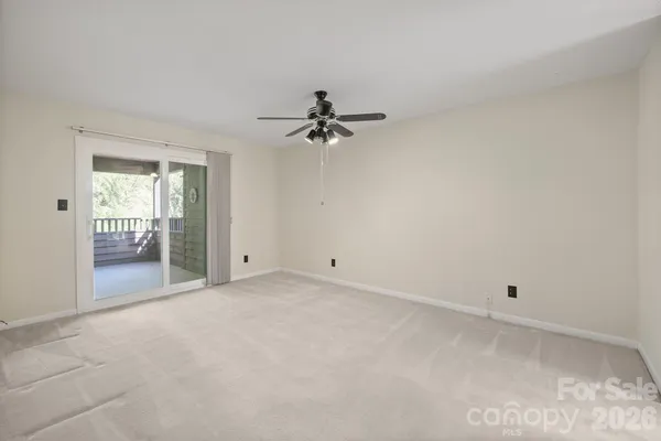 a view of a room with a ceiling fan and a window