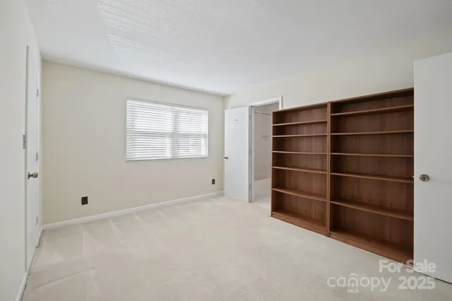 a view of an empty room with a empty space and a window