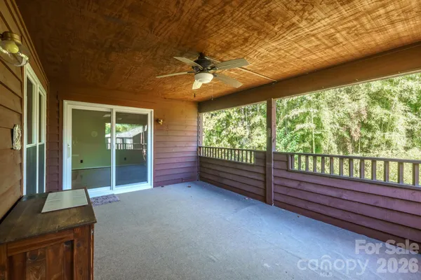 a view of a room with furniture and a large window