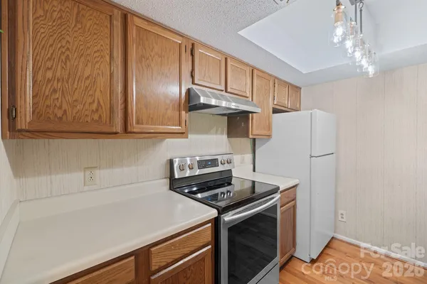 a kitchen with stainless steel appliances a stove and a refrigerator