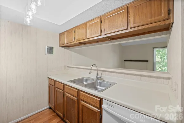 a kitchen with stainless steel appliances granite countertop a sink and cabinets