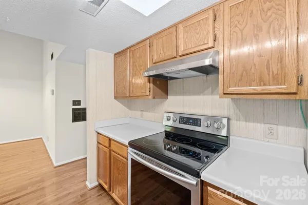 a kitchen with a stove and a microwave