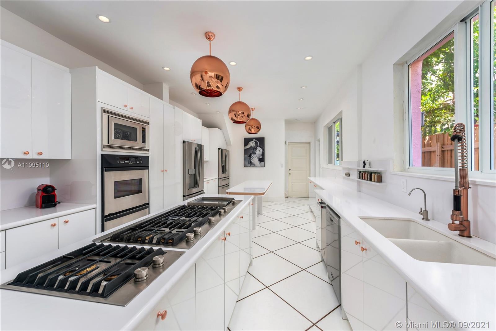 5454 Pine Tree Drive Miami Beach, FL 33140 - Photo 15 of 33 a kitchen with a stove and a sink
