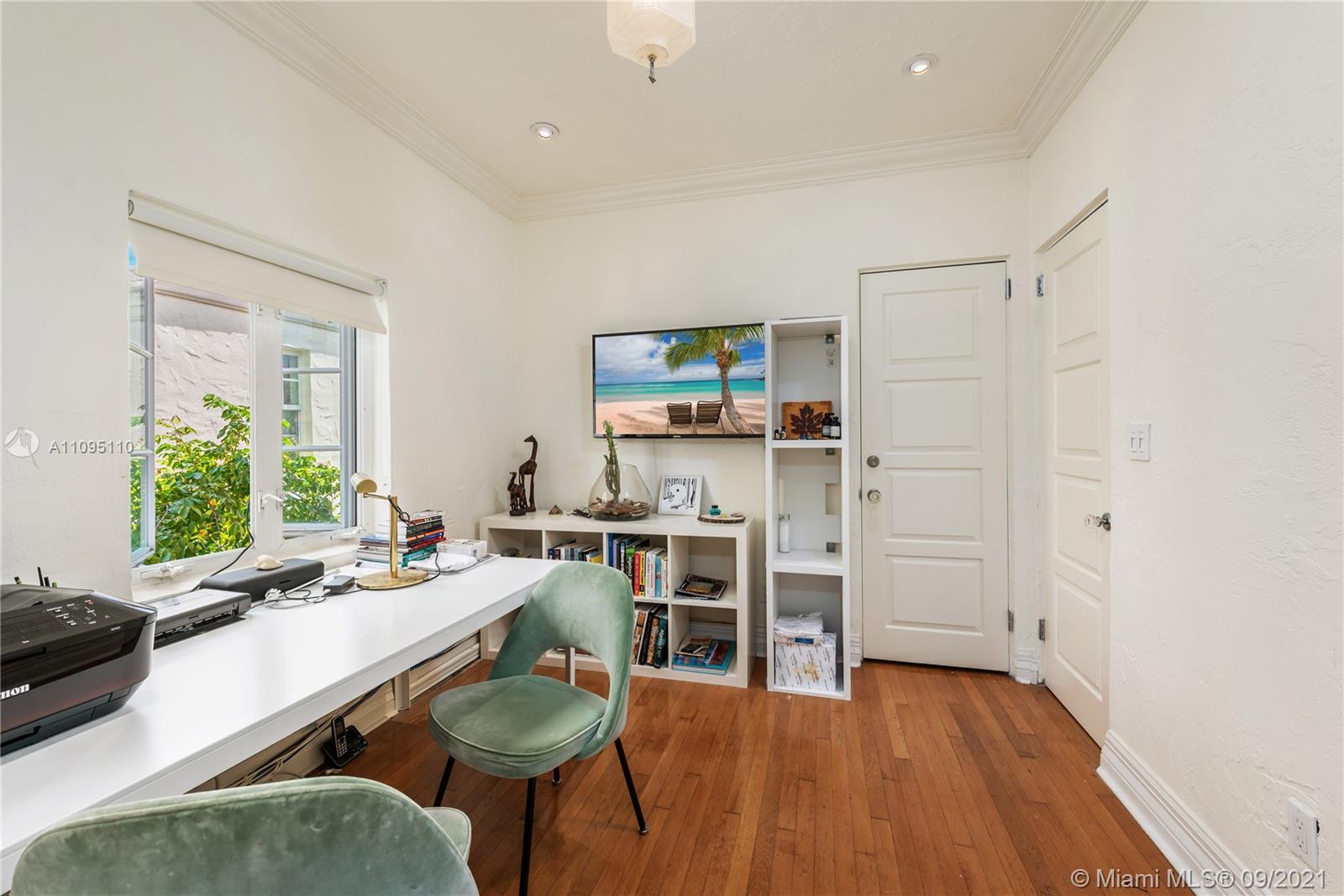 5454 Pine Tree Drive Miami Beach, FL 33140 - Photo 22 of 33 a room with stainless steel appliances a dining table chairs and wooden floor