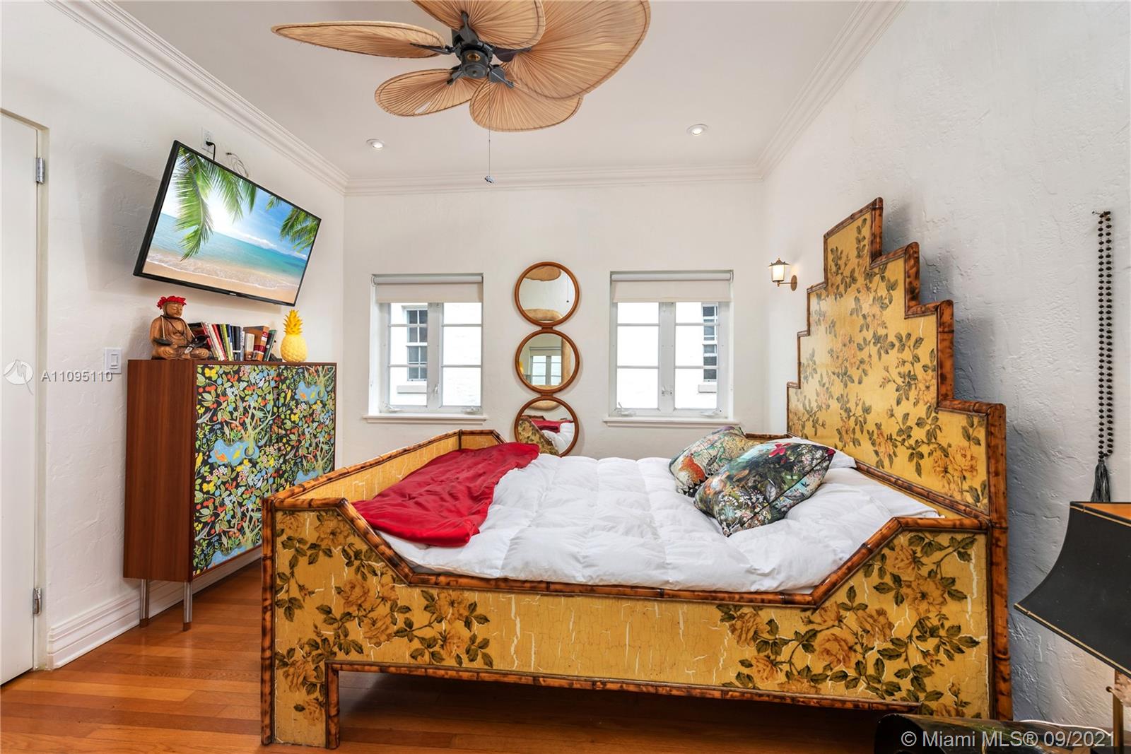 5454 Pine Tree Drive Miami Beach, FL 33140 - Photo 23 of 33 a bedroom with a bed and a flat screen tv