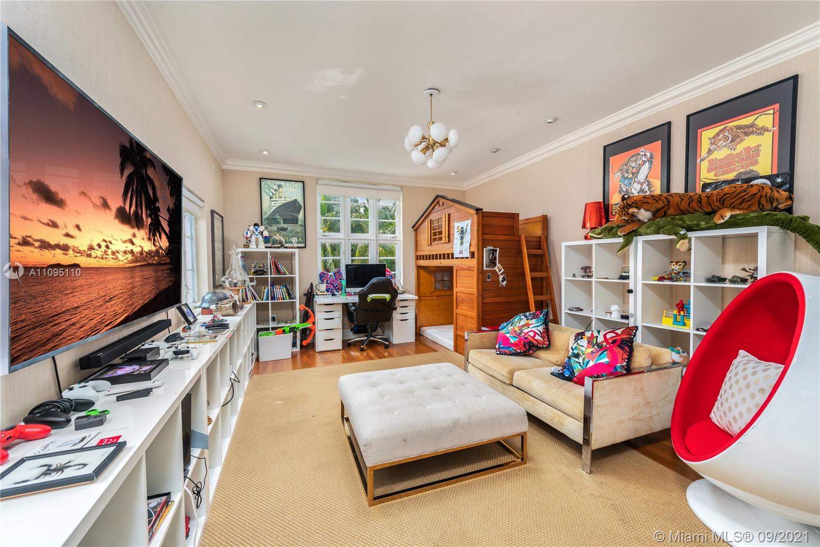 5454 Pine Tree Drive Miami Beach, FL 33140 - Photo 25 of 33 a living room with furniture and a flat screen tv