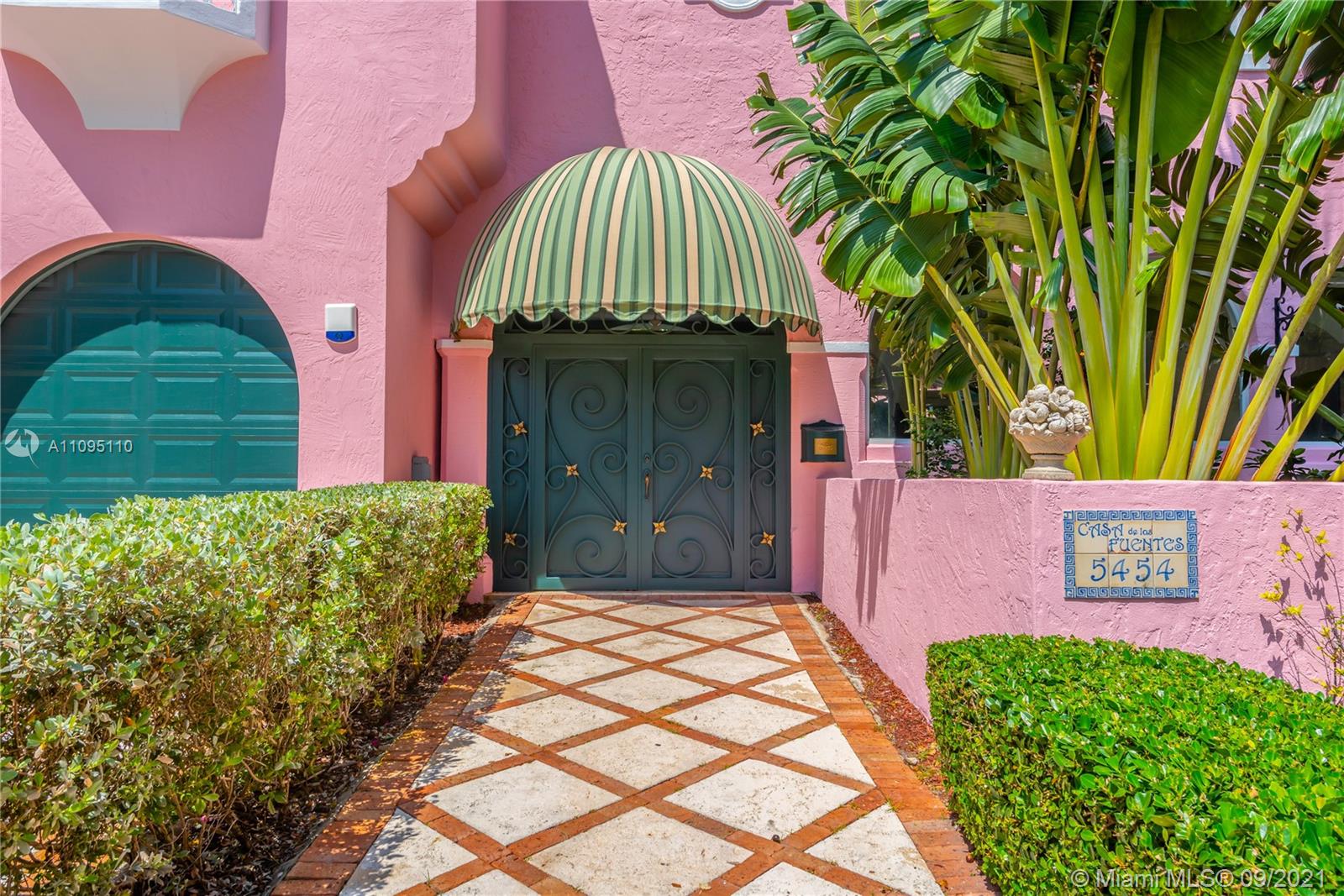 5454 Pine Tree Drive Miami Beach, FL 33140 - Photo 32 of 33 a front view of a house with a garden