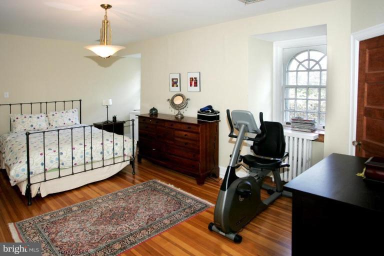 2946 Upton Street Northwest Washington, DC 20008 - Photo 14 of 22 a bedroom with a bed and a window