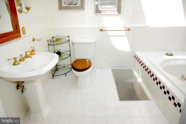 2946 Upton Street Northwest Washington, DC 20008 - Photo 15 of 22 a bathroom with a sink a toilet and bathtub