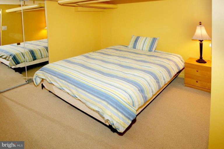 2946 Upton Street Northwest Washington, DC 20008 - Photo 18 of 22 a bedroom with a bed and wooden floor