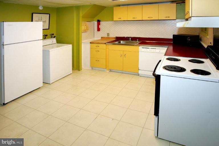 2946 Upton Street Northwest Washington, DC 20008 - Photo 19 of 22 a kitchen with a stove a sink and a refrigerator