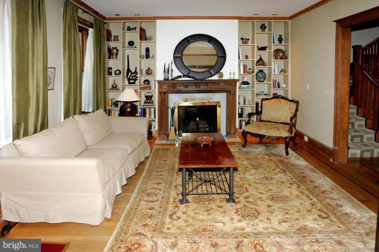 2946 Upton Street Northwest Washington, DC 20008 - Photo 3 of 22 a living room with furniture a rug and a fireplace