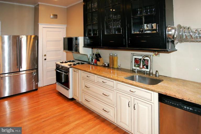 2946 Upton Street Northwest Washington, DC 20008 - Photo 6 of 22 a kitchen with stainless steel appliances granite countertop a refrigerator a stove and a sink with wooden floor