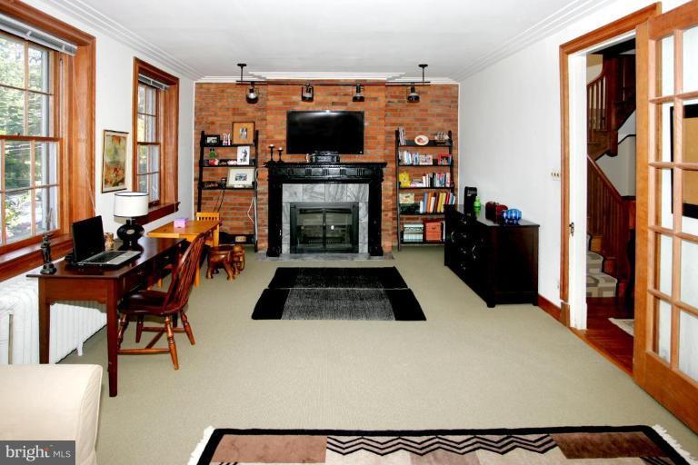 2946 Upton Street Northwest Washington, DC 20008 - Photo 10 of 22 a living room with furniture a flat screen tv and a fireplace