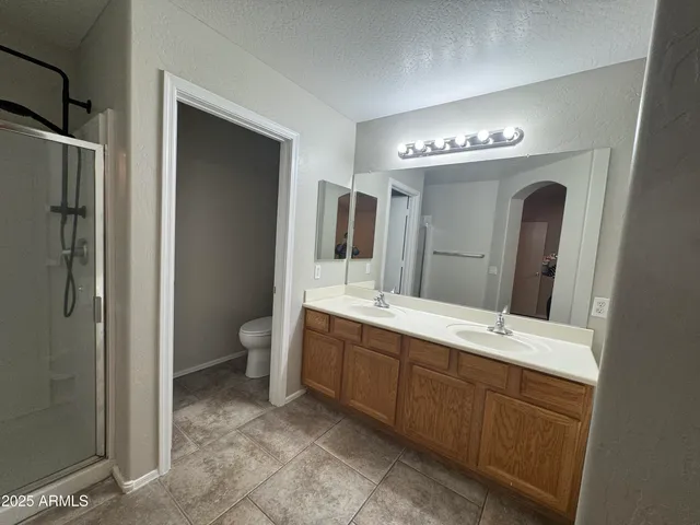 a spacious bathroom with a double vanity sink mirror and toilet
