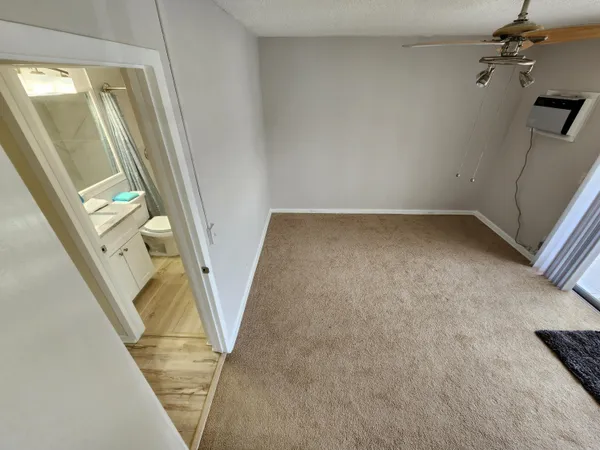 a bathroom with a granite countertop toilet and a sink
