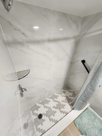 a bathroom with a bathtub and shower
