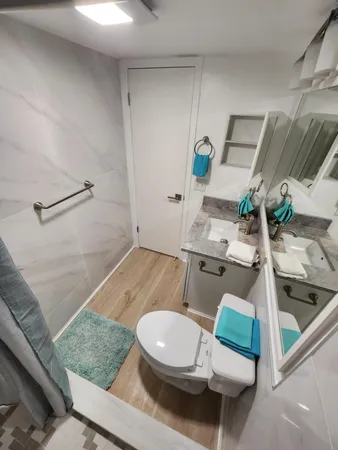 a bathroom with a sink mirror vanity and toilet
