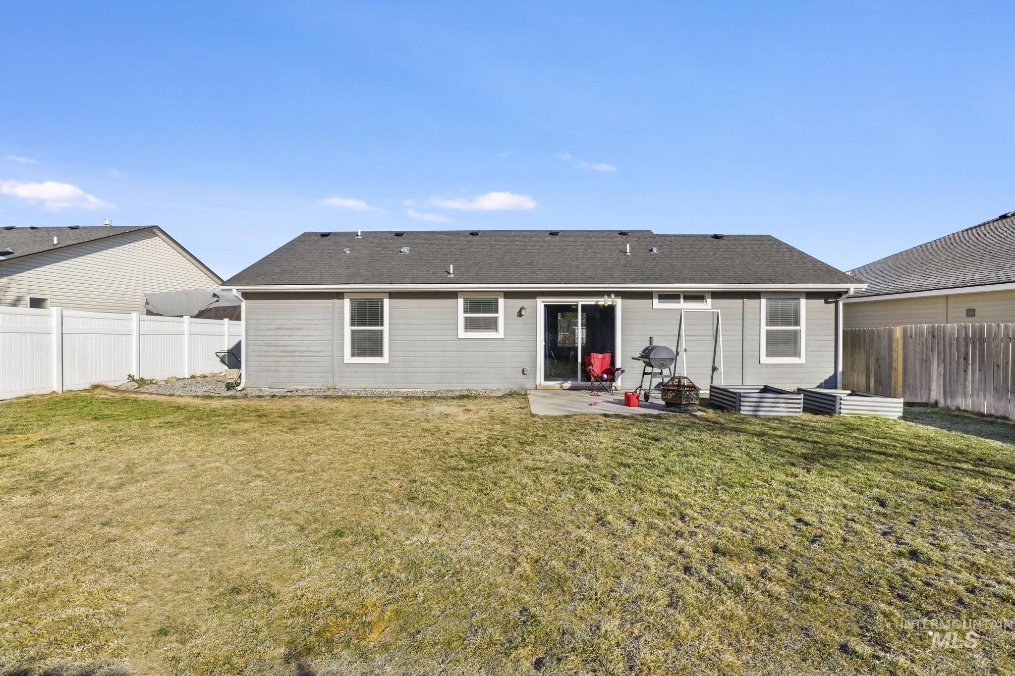 370 Feather Avenue Twin Falls, ID 83301 - Photo 11 of 17 Rear view of house featuring a patio, a fenced backyard, and a shingled roof