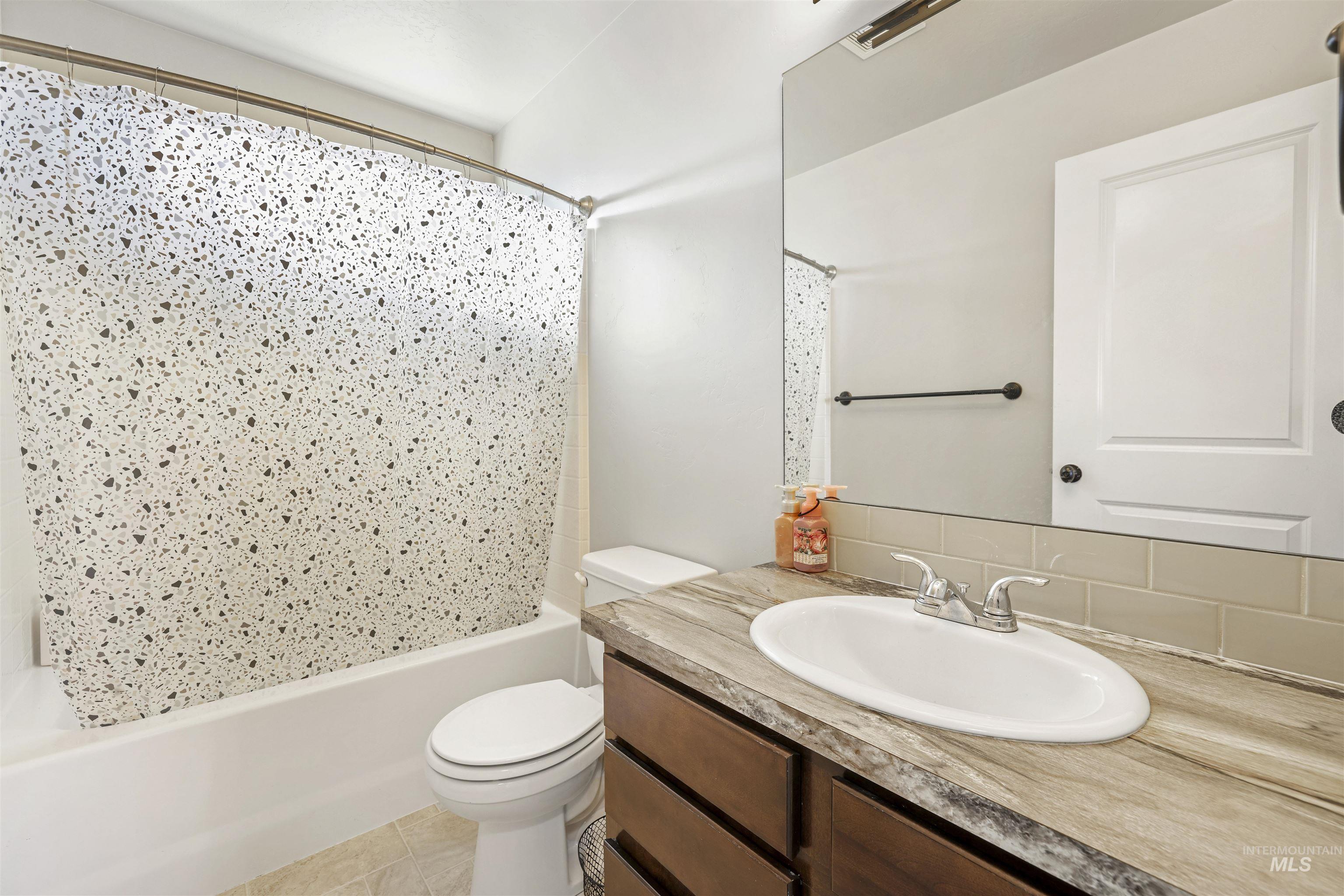 370 Feather Avenue Twin Falls, ID 83301 - Photo 17 of 17 Bathroom featuring vanity and shower / tub combo with curtain