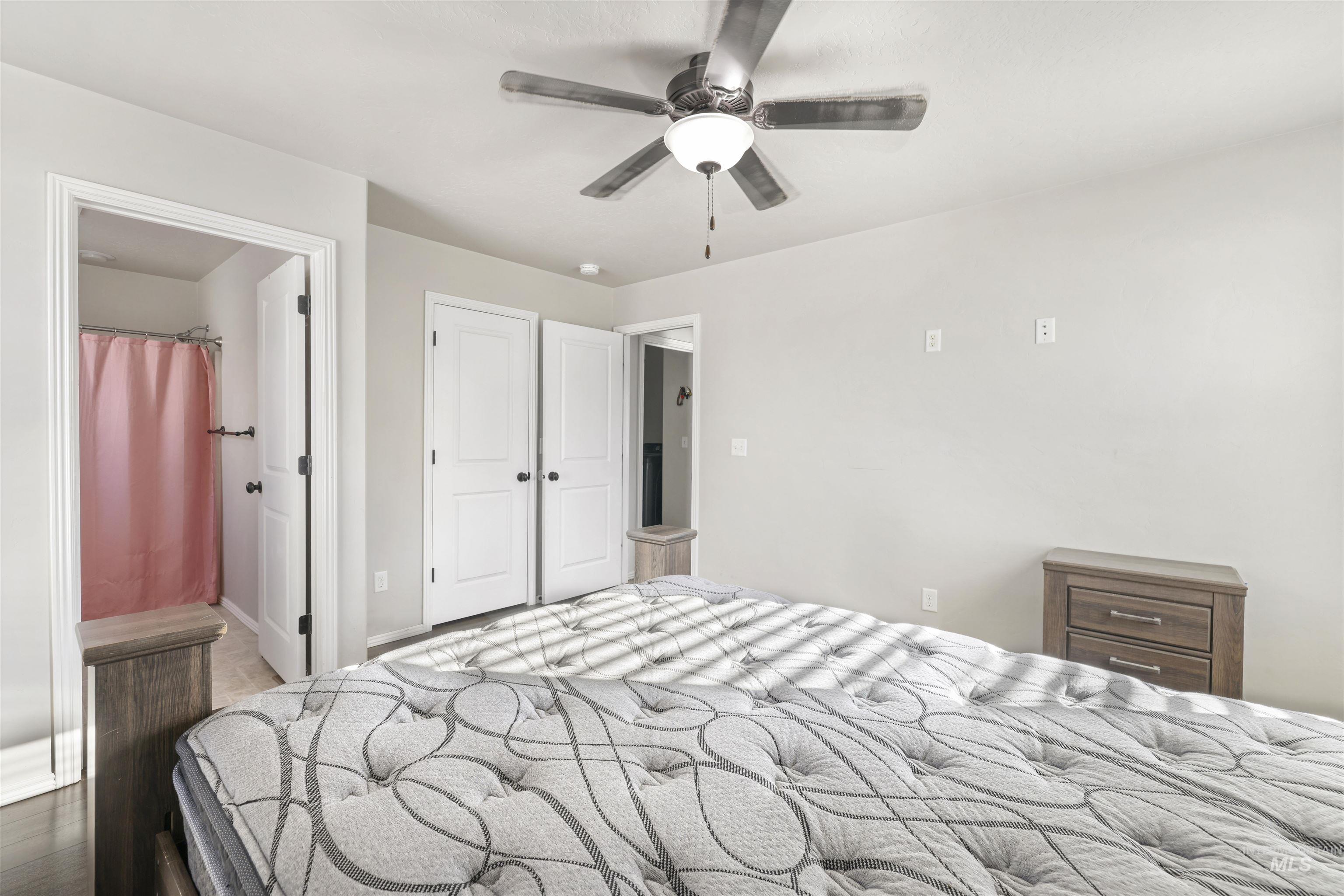370 Feather Avenue Twin Falls, ID 83301 - Photo 2 of 17 Bedroom featuring ensuite bathroom, ceiling fan, and wood finished floors