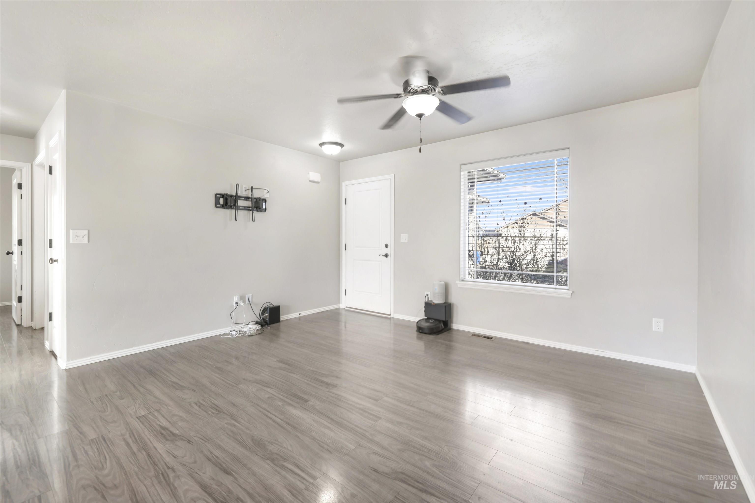 370 Feather Avenue Twin Falls, ID 83301 - Photo 4 of 17 Unfurnished living room featuring wood finished floors and a ceiling fan