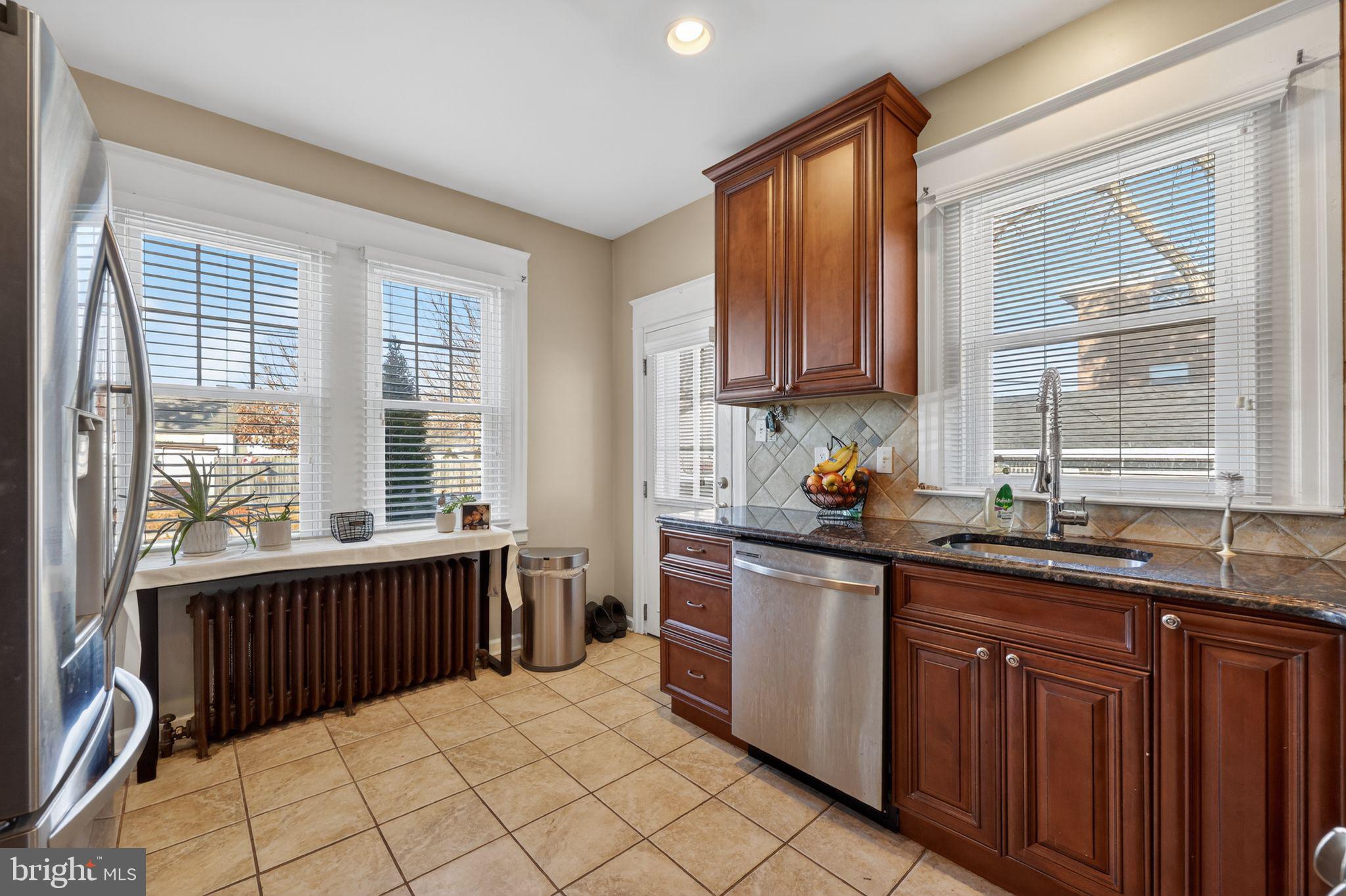 801 Chandler Street Philadelphia, PA 19111 - Photo 15 of 30 a kitchen with granite countertop a sink and a window