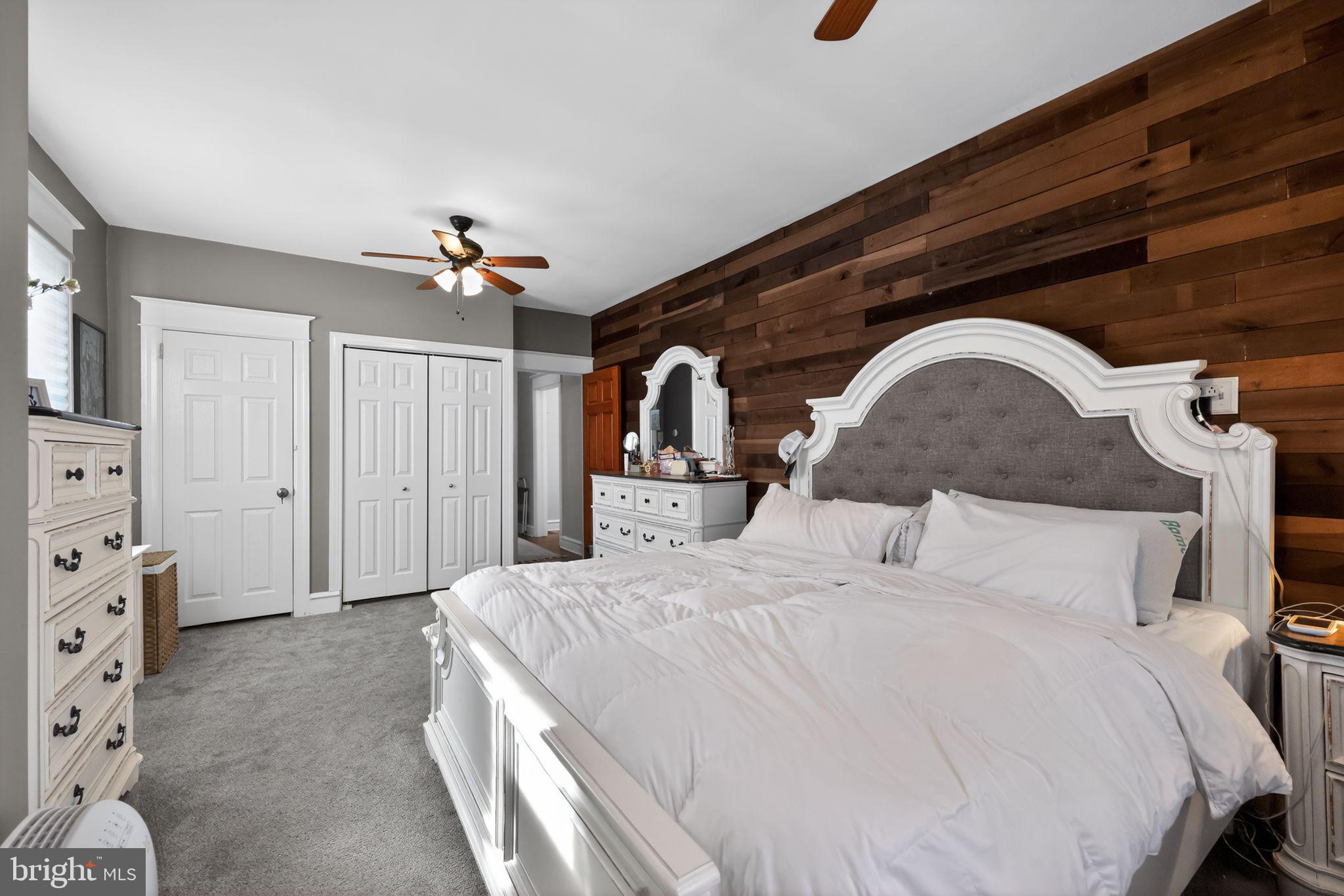 801 Chandler Street Philadelphia, PA 19111 - Photo 16 of 30 a bedroom with a bed a mirror and lamp on dresser