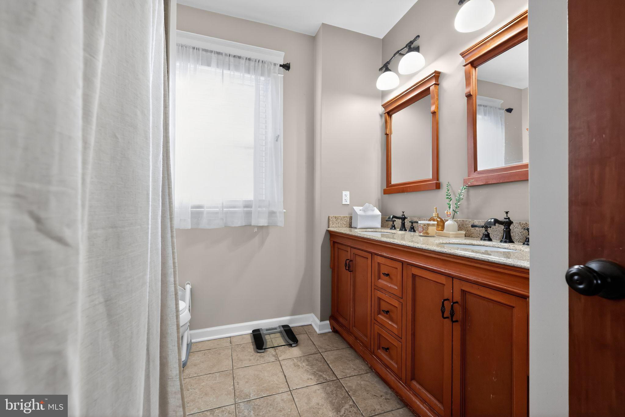801 Chandler Street Philadelphia, PA 19111 - Photo 18 of 30 a spacious bathroom with a mirror a double vanity sink and a mirror