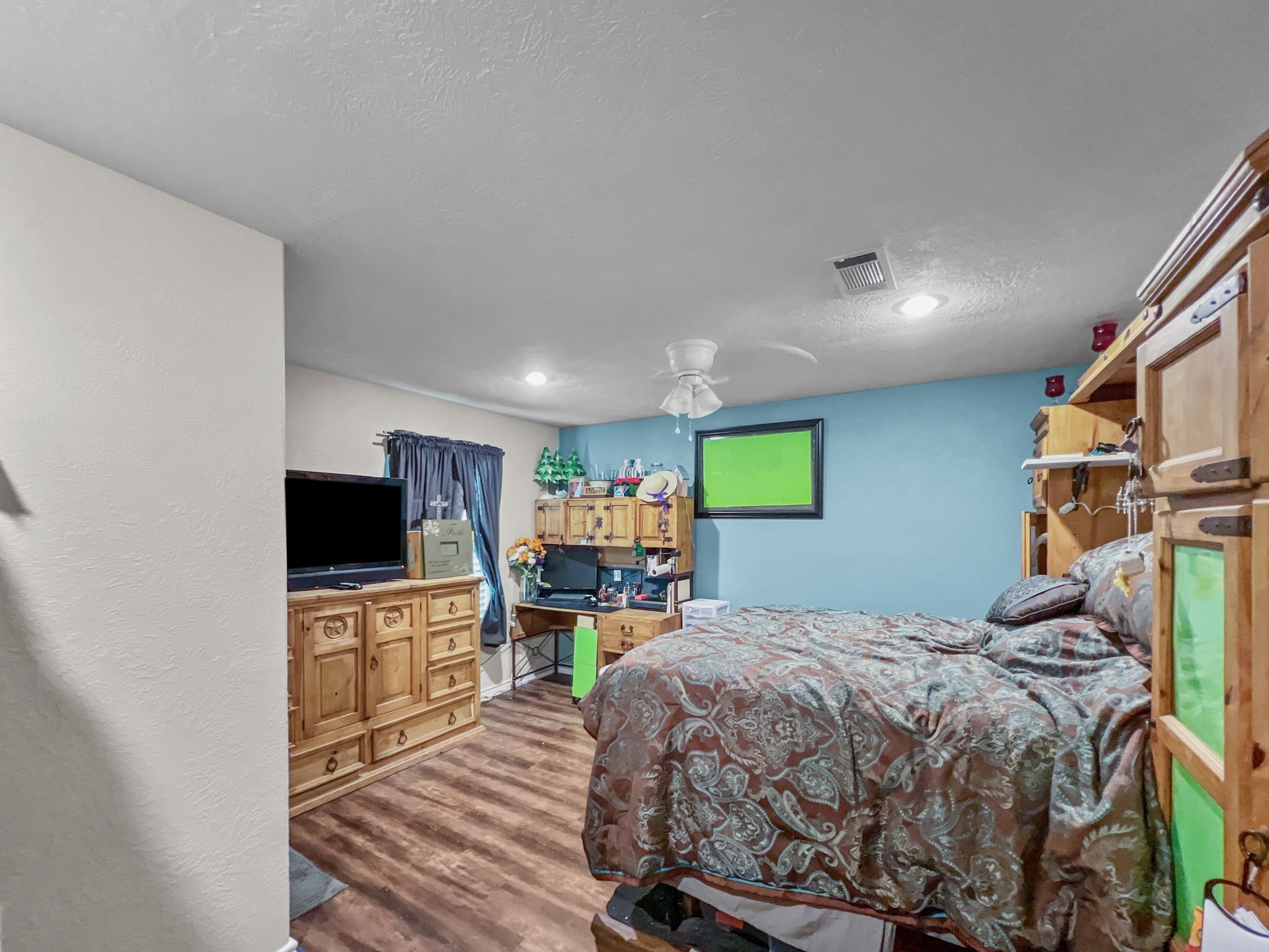 1015 Mitchell Street Sour Lake, TX 77659 - Photo 11 of 19 a bedroom with a bed and a flat screen tv