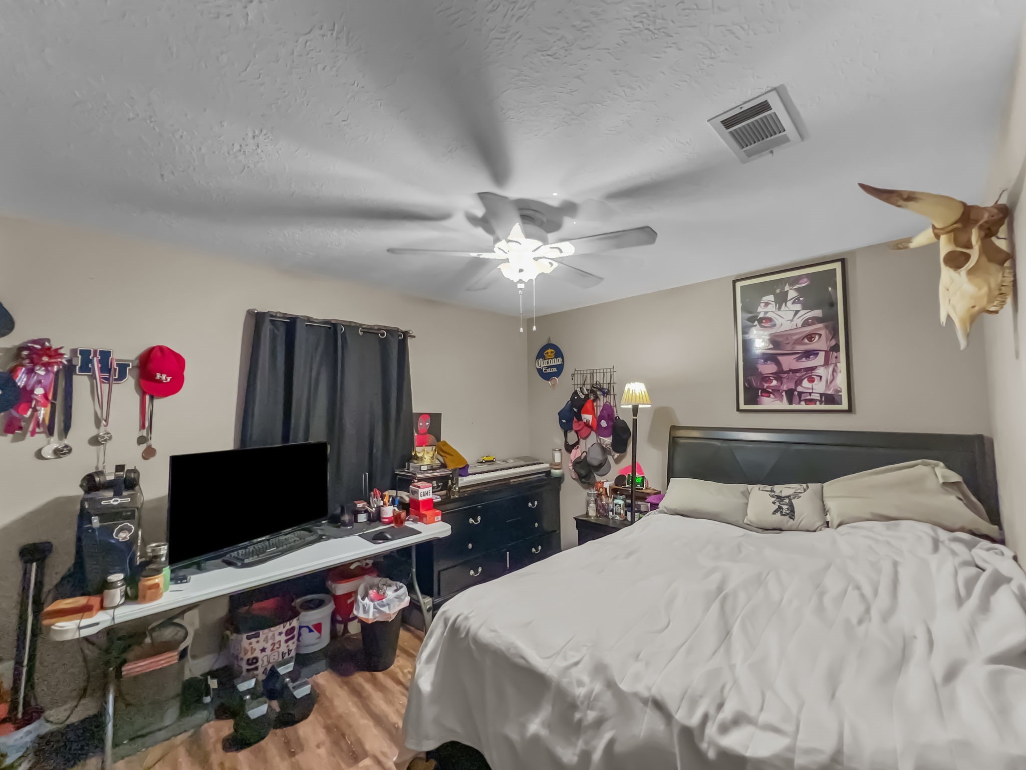 1015 Mitchell Street Sour Lake, TX 77659 - Photo 13 of 19 a bedroom with a bed and a flat screen tv