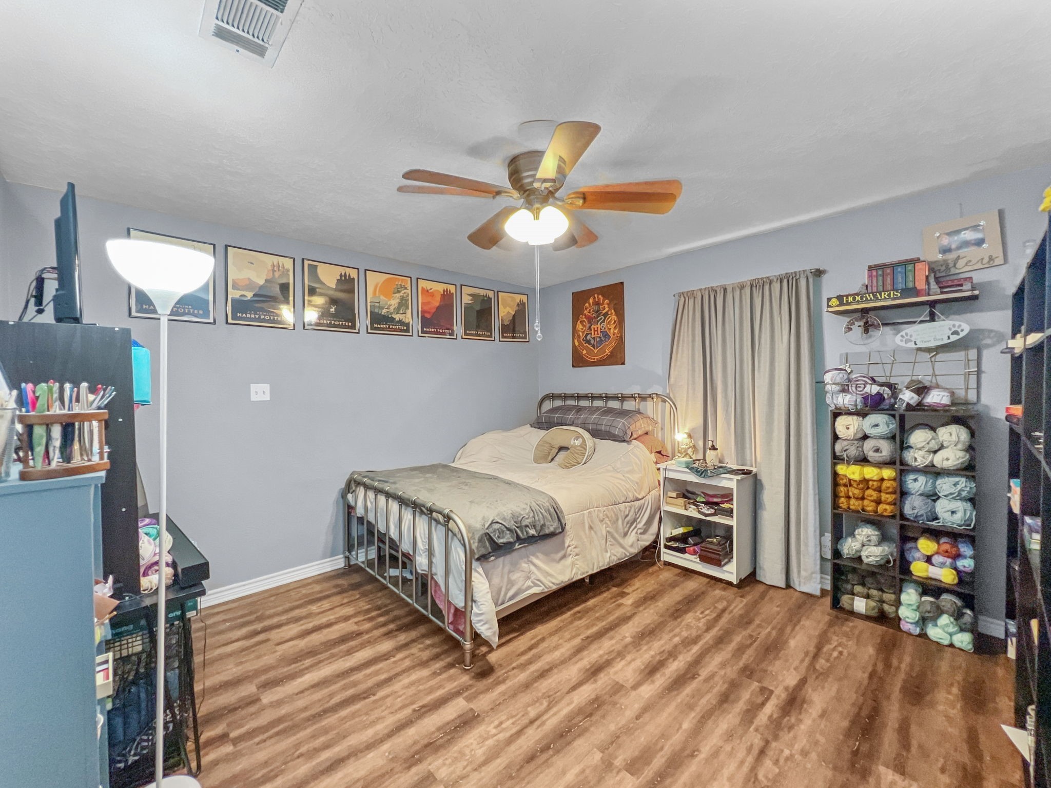 1015 Mitchell Street Sour Lake, TX 77659 - Photo 14 of 19 a bedroom with a bed and a chandelier