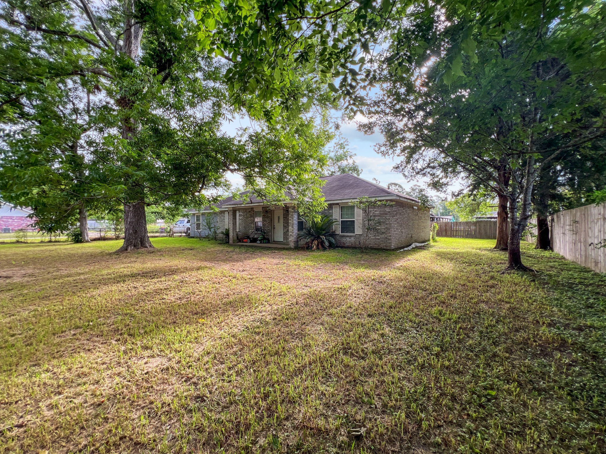 1015 Mitchell Street Sour Lake, TX 77659 - Photo 18 of 19 a front view of a house with a yard and trees