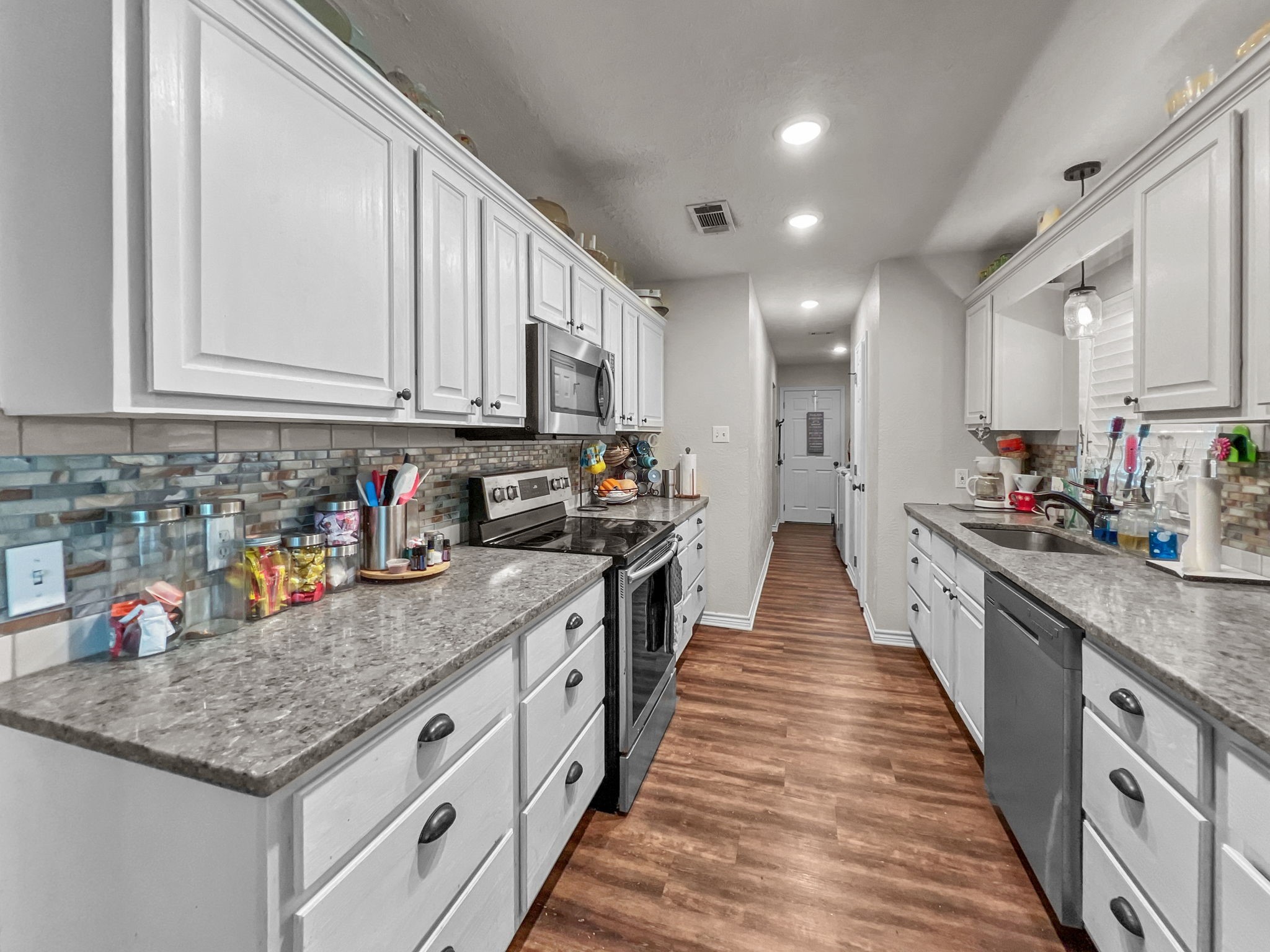 1015 Mitchell Street Sour Lake, TX 77659 - Photo 7 of 19 a large kitchen with stainless steel appliances granite countertop a lot of counter space