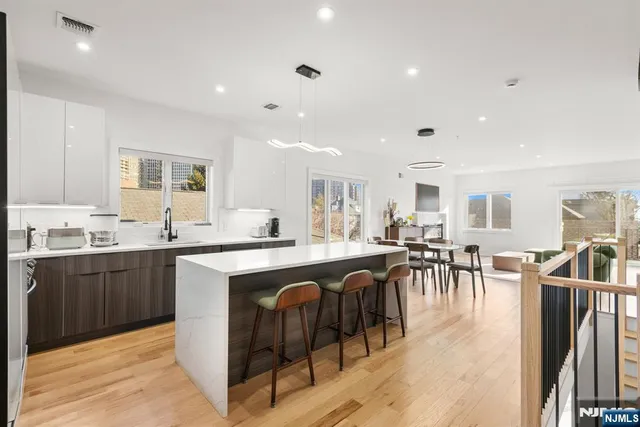 a large kitchen with lots of counter a sink and cabinets