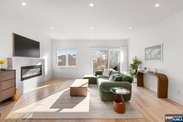 a living room with furniture fireplace and flat screen tv