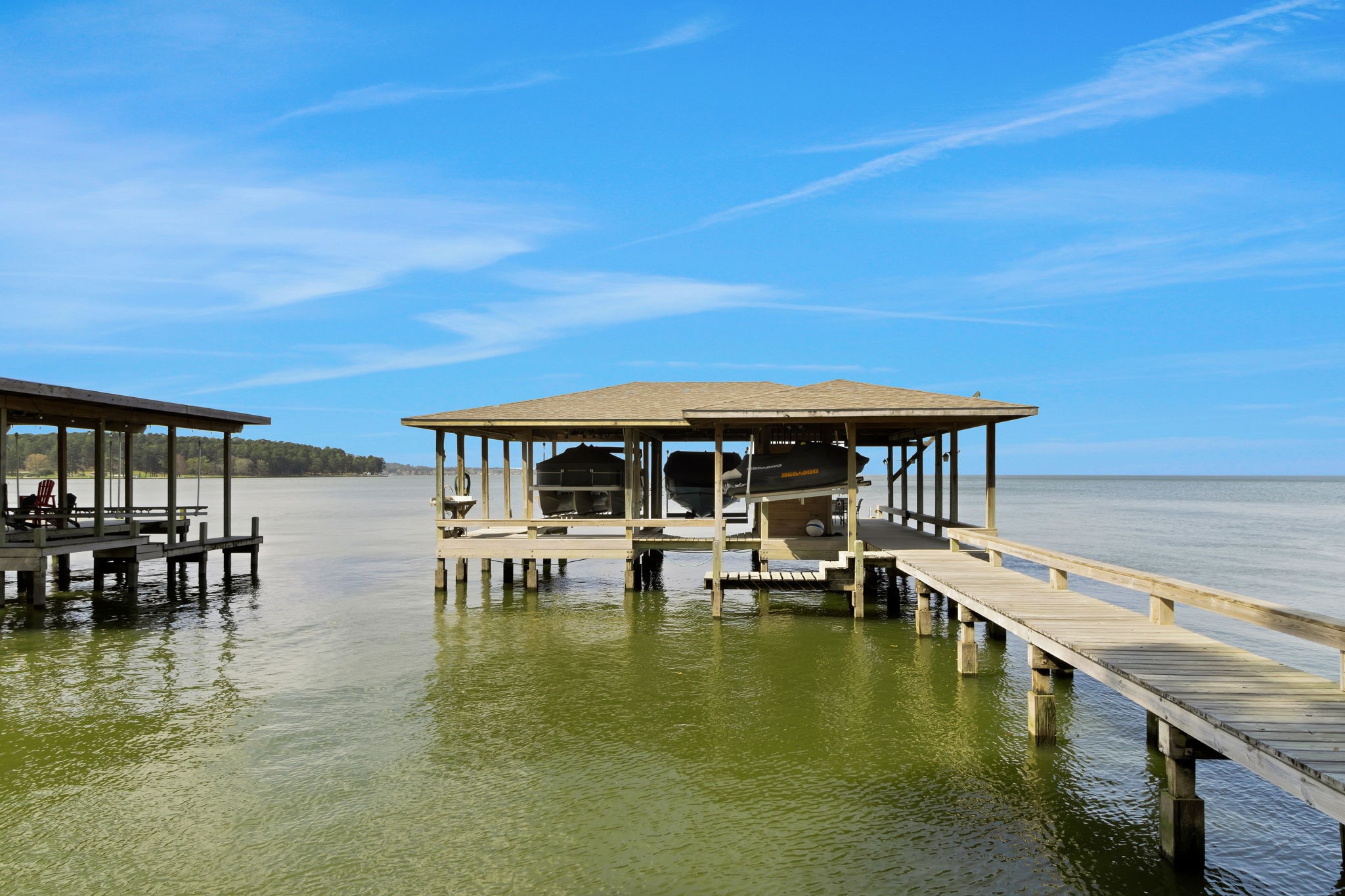 40 Pebble Beach Circle Coldspring, TX 77331 - Photo 36 of 50 The home has an outstanding boathouse with two boat lifts, jet ski lifts, storage room, sink and seating area